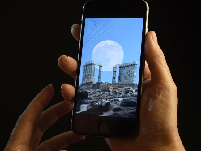 This July 21, 2016 photo shows a smartphone held for a photograph in New York. In a letter published Wednesday, July 22, 2016 in the New England Journal of Medicine, doctors detailed separate cases of two women who experienced "transient smartphone blindness" for months. Doctors discovered it was caused when they looked at their device with one eye while in bed in the dark _ and their other eye covered by a pillow. (AP Photo/Patrick Sison)