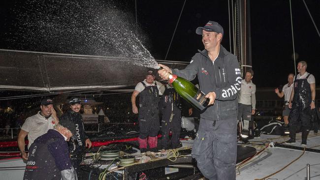 Andoo Comanche skipper John Winning Jr and his crew celebrate their Sydney to Hobart line honours victory. Picture: Chris Kidd