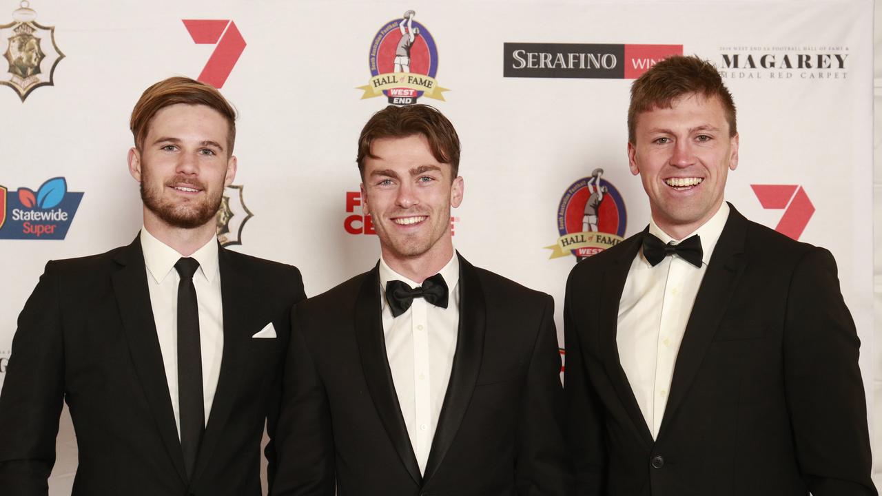 Glenelg players Jonty Scharenberg, Luke Partington and Luke Reynolds at Monday night’s Magarey Medal at adelaide Oval. Picture: MATT LOXTON