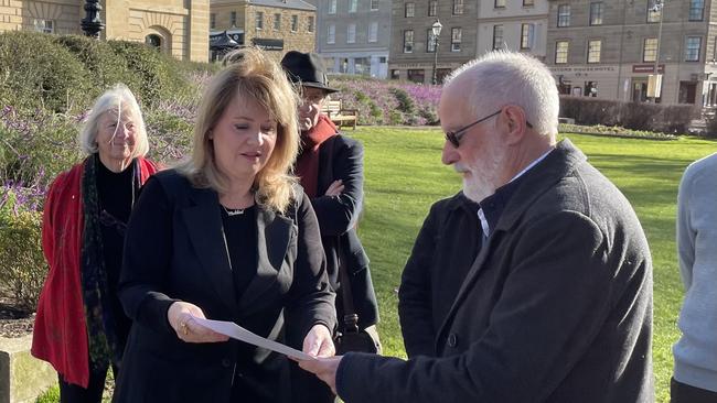 Professor Jim Reid hands Member for Clark, Madeleine Ogilvie, a letter co-signed by 55 former and current UTAS academics. Picture: Duncan Abey