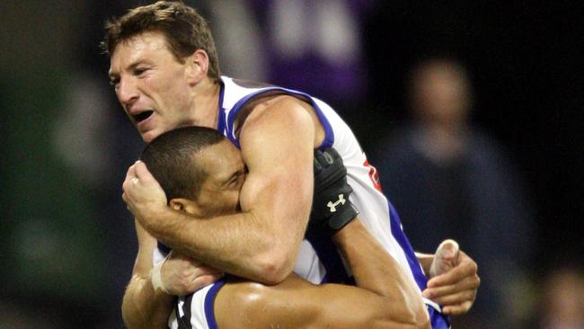 Brent Harvey and Josh Gibson celebrate a North Melbourne win on the Gold Coast in 2008.