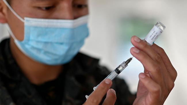 Gold Coast Health staff must be fully vaccinated by the end of October or they’ll be placed on leave indefinitely. (Photo by Johan ORDONEZ / AFP)