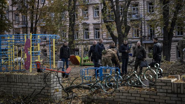 Emergency service personnel attend to the site of a blast next to a playground in a park in Kyiv on Monday. Picture: Getty Images