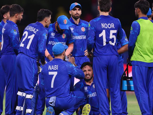 Gulbadin Naib goes down with a suspected injury late in the game. Picture: Darrian Traynor-ICC/ICC via Getty Images