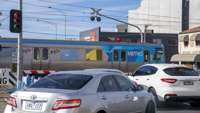 Traffic is held up by boom gates on Glenroy Rd in Glenroy. Picture: Andy Brownbill