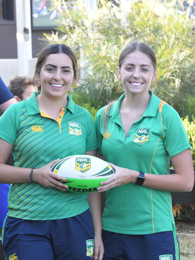 Keisha Waite and Tayla Merrick from the NRL help children pass-the-ball at Moorebank Sports Club.