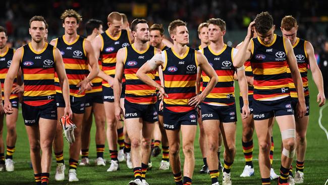 Disappointed Crows players trudge off Adelaide Oval after their loss to Collingwood. Picture: Mark Brake/Getty Images