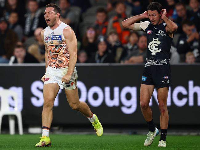 Milestone man Toby Greene celebrates in front of Blue Ollie Hollands. Picture: Morgan Hancock/Getty Images