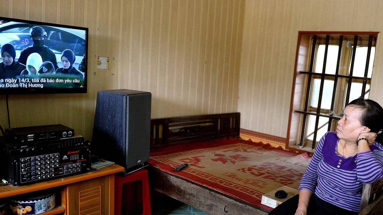 Nguyen Thi Vy, stepmother of Doan Thi Huong, watches the news from Malaysia. Picture: AFP