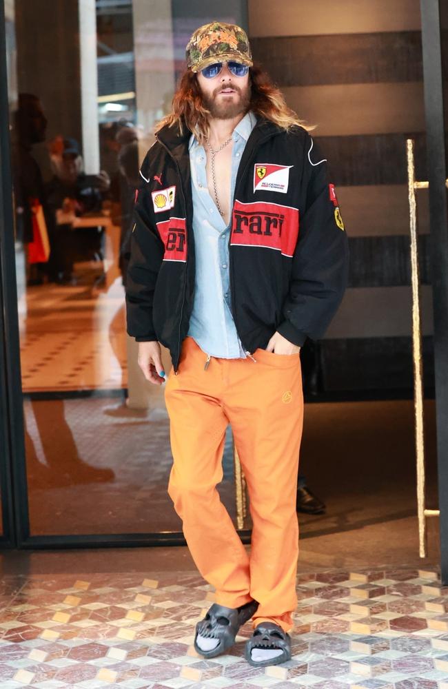 Jared Leto made a feeble attempt at being low key in his Ferrari branded jacket, bright orange pants and socks and skull sandals. Picture: affinitypicture/Backgrid