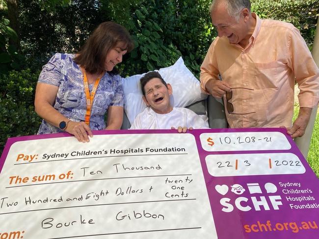 Bourke Gibbons, with his brother Scott (right,) presented his last fundraising cheque to The Children's Hospital, Westmead, just days before his death on April 2. Picture: Supplied by Gibbons' family