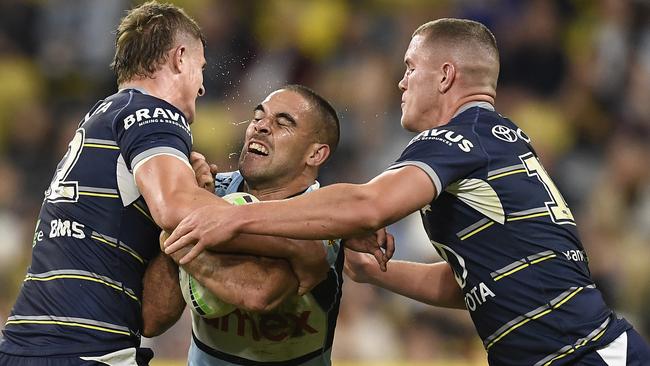 TOWNSVILLE, AUSTRALIA – JUNE 18: William Kennedy of the Sharks is tackled by Mitch Dunn and Tom Gilbert of the Cowboys during the round 15 NRL match between the North Queensland Cowboys and the Cronulla Sharks at QCB Stadium, on June 18, 2021, in Townsville, Australia. (Photo by Ian Hitchcock/Getty Images)