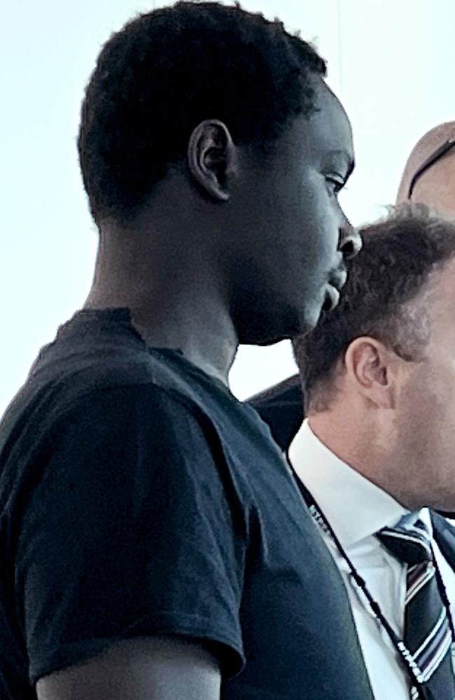 22-year-old Koang Wuordol, extradited over the murder of Sudanese teenager Yiel Gatluak, boards a Qantas flight at Melbourne Airport. PICTURE: NCA Newswire / Nicki Connolly