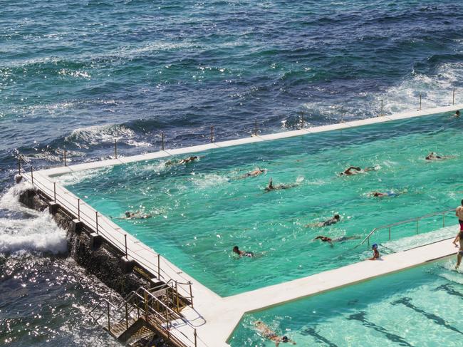 ESCAPE:  Sydney, Australia - January 23, 2019: People swimming in the fresh water swimming pools built in to the sea with waves rolling in to Bondi and breaking against the edge of the pool Picture: Istock