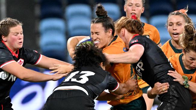 Australia's Maya Stewart (C) is tackled by Canada's Fancy Bermudez (2nd L) during the a Womenâs Rugby Union match between Australia and Canada at the Alliance Stadium in Sydney on May 11, 2024. (Photo by Saeed KHAN / AFP) / -- IMAGE RESTRICTED TO EDITORIAL USE - STRICTLY NO COMMERCIAL USE --