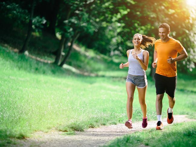 Healthy couple jogging in nature in good spirit