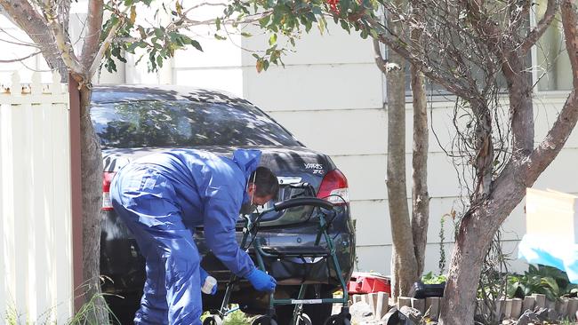 Forensics lift prints from a walker at the scene of the murder of Philip Steele in Lonus Street, Whitebridge, 2018. Picture by Peter Lorimer.