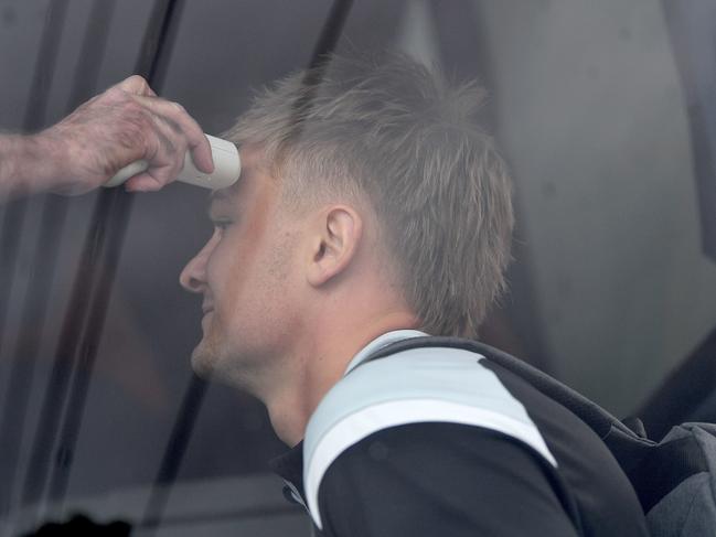 Power’s Ollie Wines is temperature tested as he boards a bus at Alberton Oval headed to the airport for a flight to the AFL’s hub on the Gold Coast. Picture: AAP Image/David Mariuz