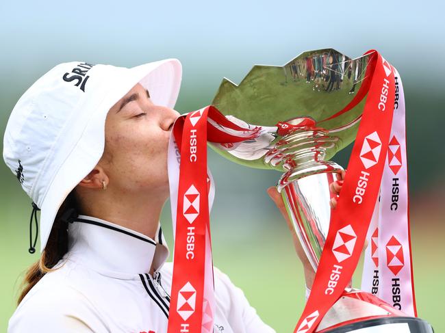 SINGAPORE, SINGAPORE - MARCH 03: Hannah Green of Australia kisses the trophy in celebration of victory on the 18th green on Day Four of the HSBC Women's World Championship at Sentosa Golf Club on March 03, 2024 in Singapore. (Photo by Yong Teck Lim/Getty Images) *** BESTPIX ***