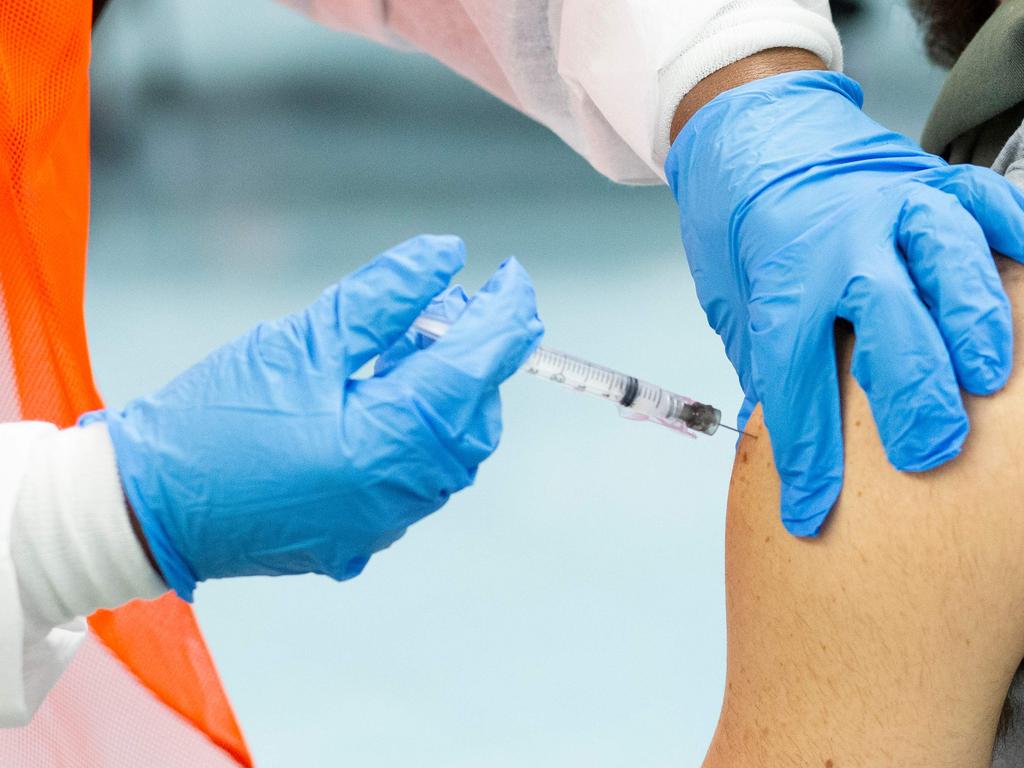 Aman receives a dose of the Moderna coronavirus vaccine at a vaccination. Picture: Kena Betancur / AFP