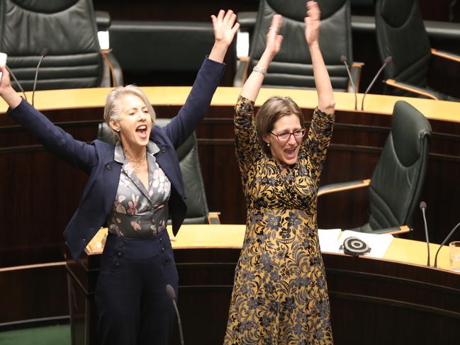 Greens leader Cassy O’Connor, right, and Rosalie Woodruff celebrate the passage of the laws.