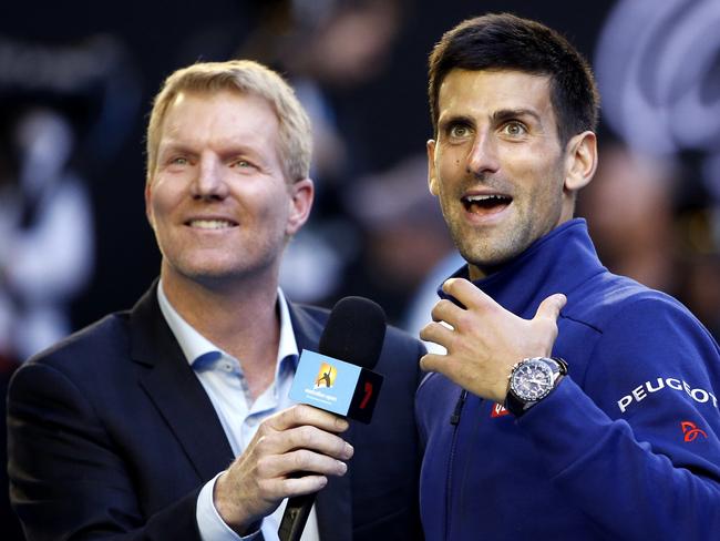 Novak Djokovic, right,  of Serbia talks with former champion Jim Courier following his fourth round win over Gilles Simon of France at the Australian Open tennis championships in Melbourne, Australia, Sunday, Jan. 24, 2016.(AP Photo/Vincent Thian)