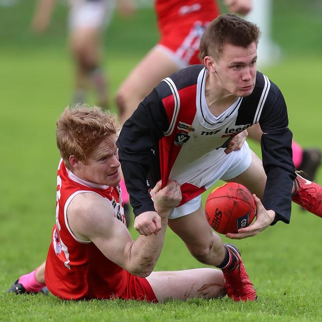 Alvie’s Alex Williamson is dragged to the ground by Birregurra’s Ben Macfarlane.