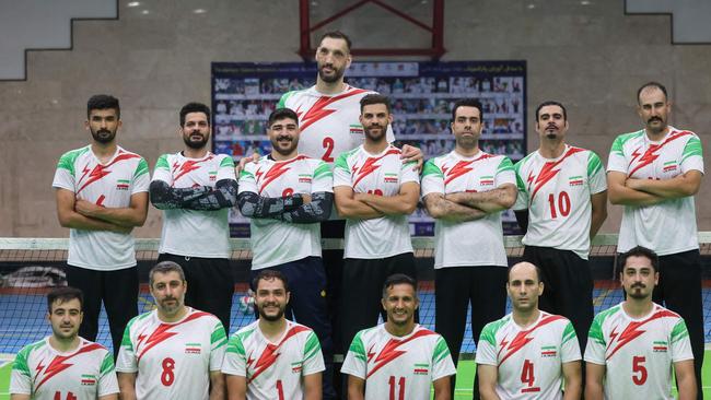 Iranian athlete Morteza Mehrzad (top C) poses for a picture with his teammates. (Photo by ATTA KENARE / AFP)