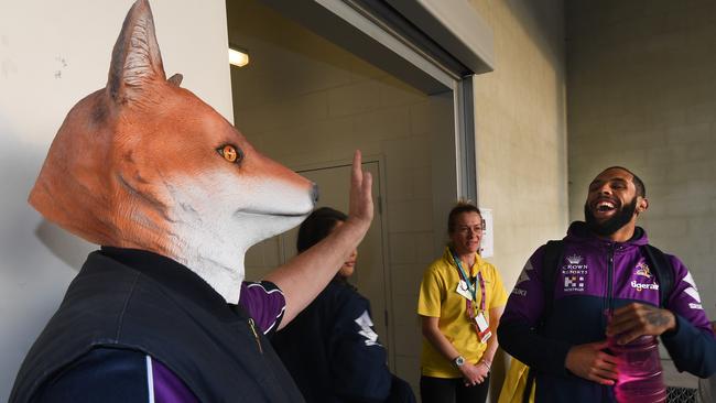 Addo-Carr, then with the Melbourne Storm, reacts as a fan dressed with a fox mask greets him in 2017. Picture: Julian Smith