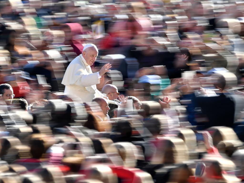 A panning photo shows Pope Francis waving to the crowd as he arrives for a weekly general audience on October 25, 2017, at St Peter's square in Vatican. Picture: AFP