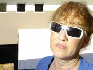 Blinded by the light: Resident Glenda Pierce of Killarney Crescent at Skennars Head, has to wear sunglasses due to the glare coming off her neighbour’s new roof. . Picture: Jerad Williams