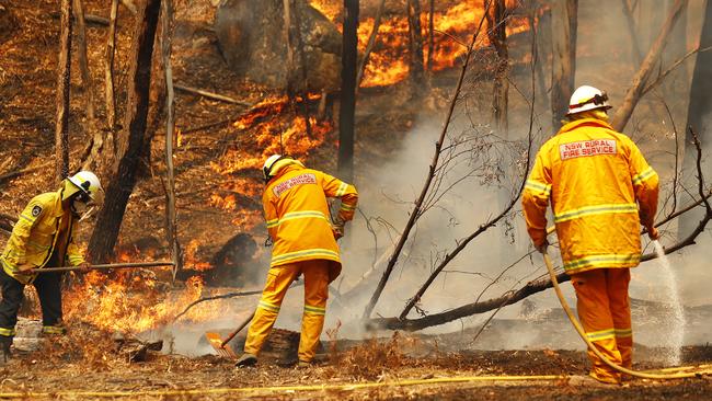 RFS crews from Sydney and the Illawarra containing the fire front burning through Ben Bullen, near Capertee, on Saturday afternoon. Picture: Sam Ruttyn