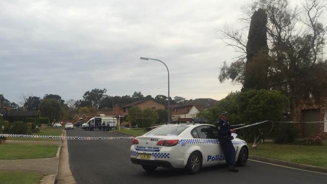 A police officer guards the scene at Links Ave, Milperra, where the body of Anne Rogers was found. Picture: James Taylor