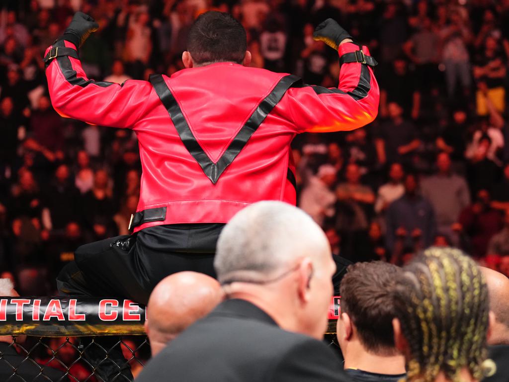 O’Malley (cornrows, bottom right) watches Dvalishvili wear his jacket. Picture: Chris Unger/Zuffa LLC via Getty Images