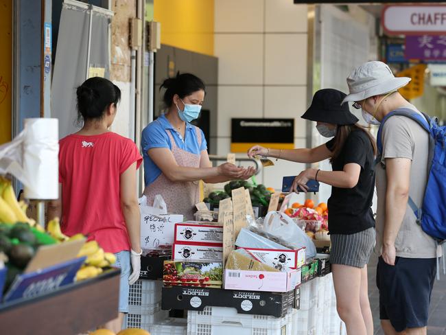 31/01/2020. Lan Zhang, working at a fruit stall in Eastwood said sheÕs wearing mask to be responsible to the community. Shopping precinct Rowe St in Eastwood in Sydney's West where concerns in the Chinese community are growing around the spread of Coronavirus, many people on the street are wearing masks as a safeguard. Britta Campion / The Australian