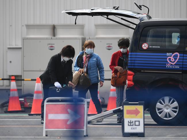 Passengers load suitcases into a car as they leave after disembarking from the Diamond Princess cruise ship. Picture: AFP