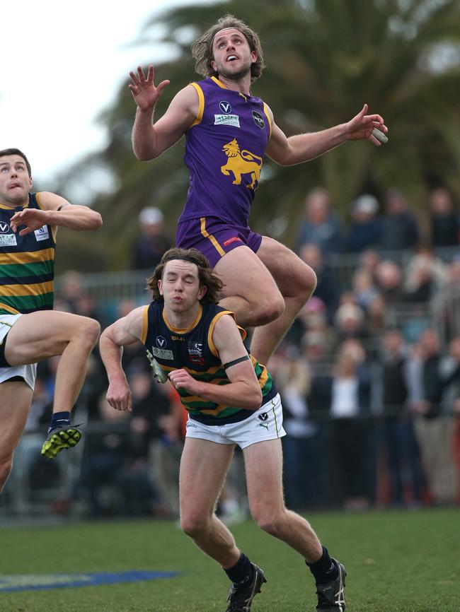 Alexander Croft (Collegians) flies high but can't mark over Lachlan Farrugia (St Kevin’s)  Picture: Hamish Blair