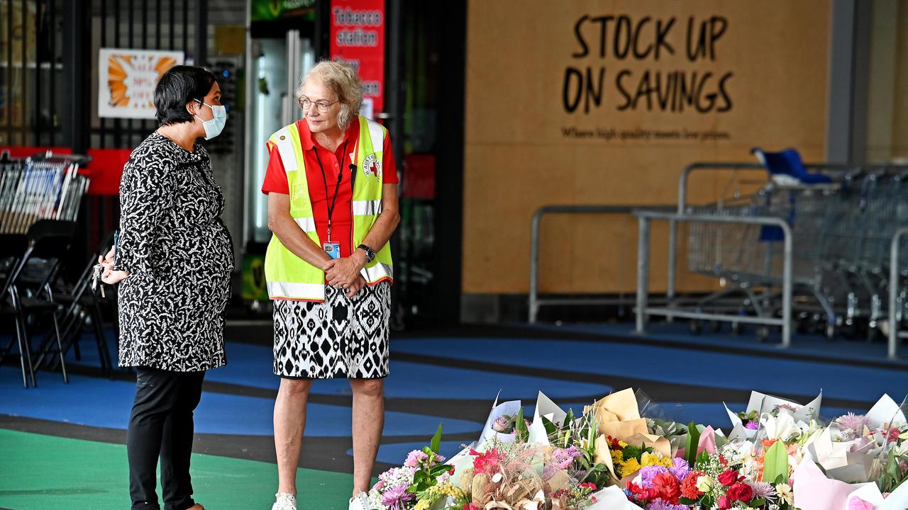 People place flowers in tribute to Vyleen White, 70, of Redbank Plains at Town Square Redbank Plains Shopping Centre. Picture: NCA NewsWIRE / John Gass