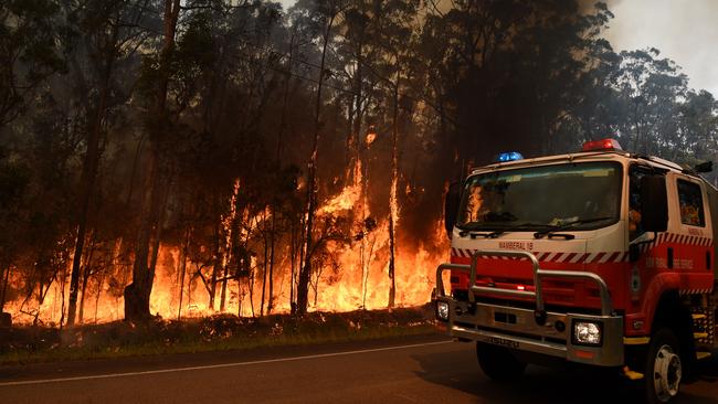 NSW Rural Fire Service firefighters oversee a backburn operation on Medowie Rd, at Medowie near Port Stephens, Monday, Nov. 7, 2016. (AAP Image/Dan Himbrechts) NO ARCHIVING