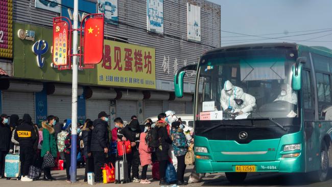 Residents queue to board a bus at Gaocheng district to be taken to centralised quarantine in Shijiazhuang, in northern China. Picture: AFP