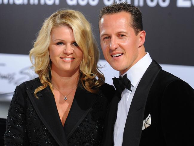 Formula-One driver Michael Schumacher and his wife Corinna arrive for the GQ gala 'Men of the Year' in Berlin on October 29, 2010.  AFP PHOTO / JENS KALAENE  GERMANY OUT / AFP PHOTO / DPA / JENS KALAENE