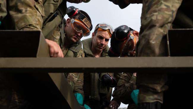 Australian Army soldiers setting up fuel deployment from hoses on the ship to the shore. Picture: Supplied.