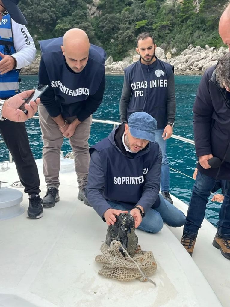 Police divers brought the natural glass to the surface to inspect it. Picture: Naples Superintendency for Archaeology, Fine Arts and Landscape