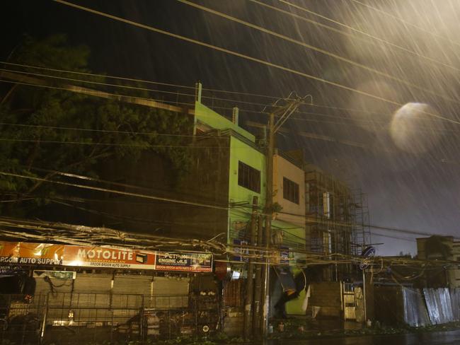 Strong winds and rain batter buildings and business establishments as Typhoon Mangkhut hits Tuguegarao city, Cagayan province, northeastern Philippines on Saturday. Picture: AP