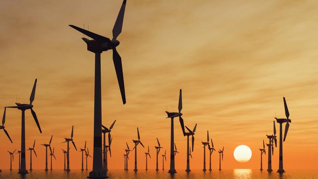 An offshore wind turbine farm at sunset.