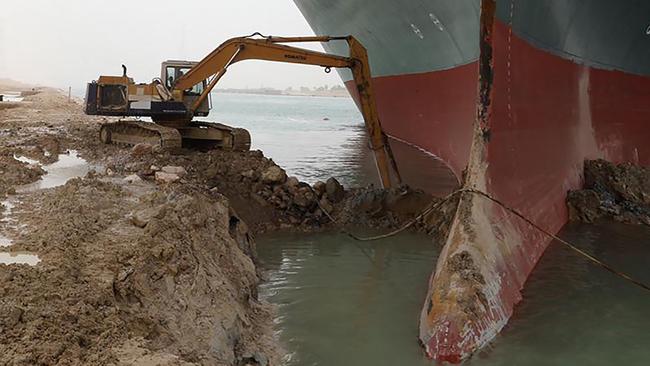 An excavator tries to free the Ever Given on March 25. Picture: AFP