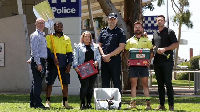 Fawkner police donate tools to the YMCA ReBuild project. (L-R) Gary Sinclair from ReBuild, employee Raheem, police property officer Karen Jones, Inspector Chris Allen and Michael and Damian Carmody from ReBuild. Picture: George Salpigtidis