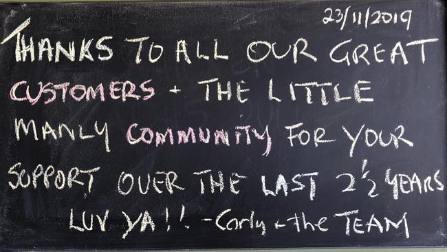 A message to customers on the blackboard at the Little Manly Beach Kiosk. Picture: Jim O'Rourke