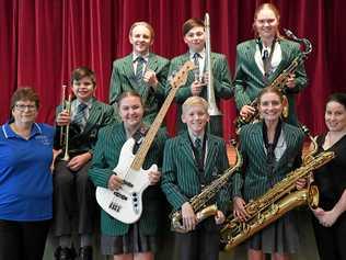 SWEET SOUND: Jeanette Douglas (musical director, Cap Winds) with TCC students Lachlan Andersen, Lachlan Winter, Jayde Ellingsen, Angus Gall, Oliver Burkhardt, Georgia Slack, Acacia-Lee Storey, and Stephanie Coughlan (acting director instrumental music, Catholic schools) look forward to Fusion 2019. Picture: Jann Houley