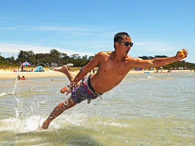 Andy Au of Kew enjoys Rye beach on December 31, 2012. Picture: Hamish Blair